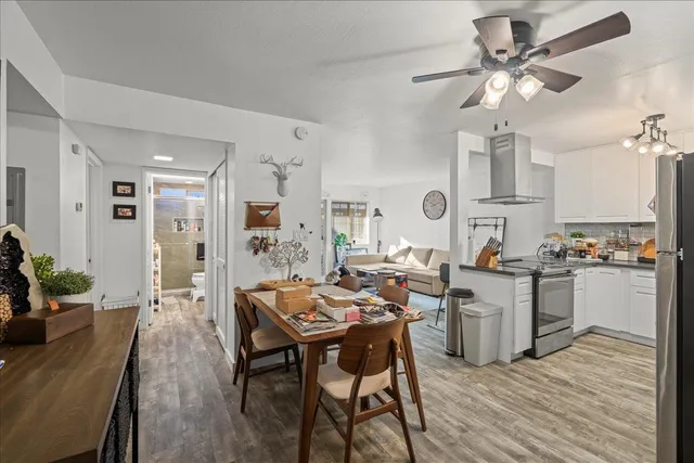 a room with stainless steel appliances kitchen island granite countertop furniture a dining table and chairs