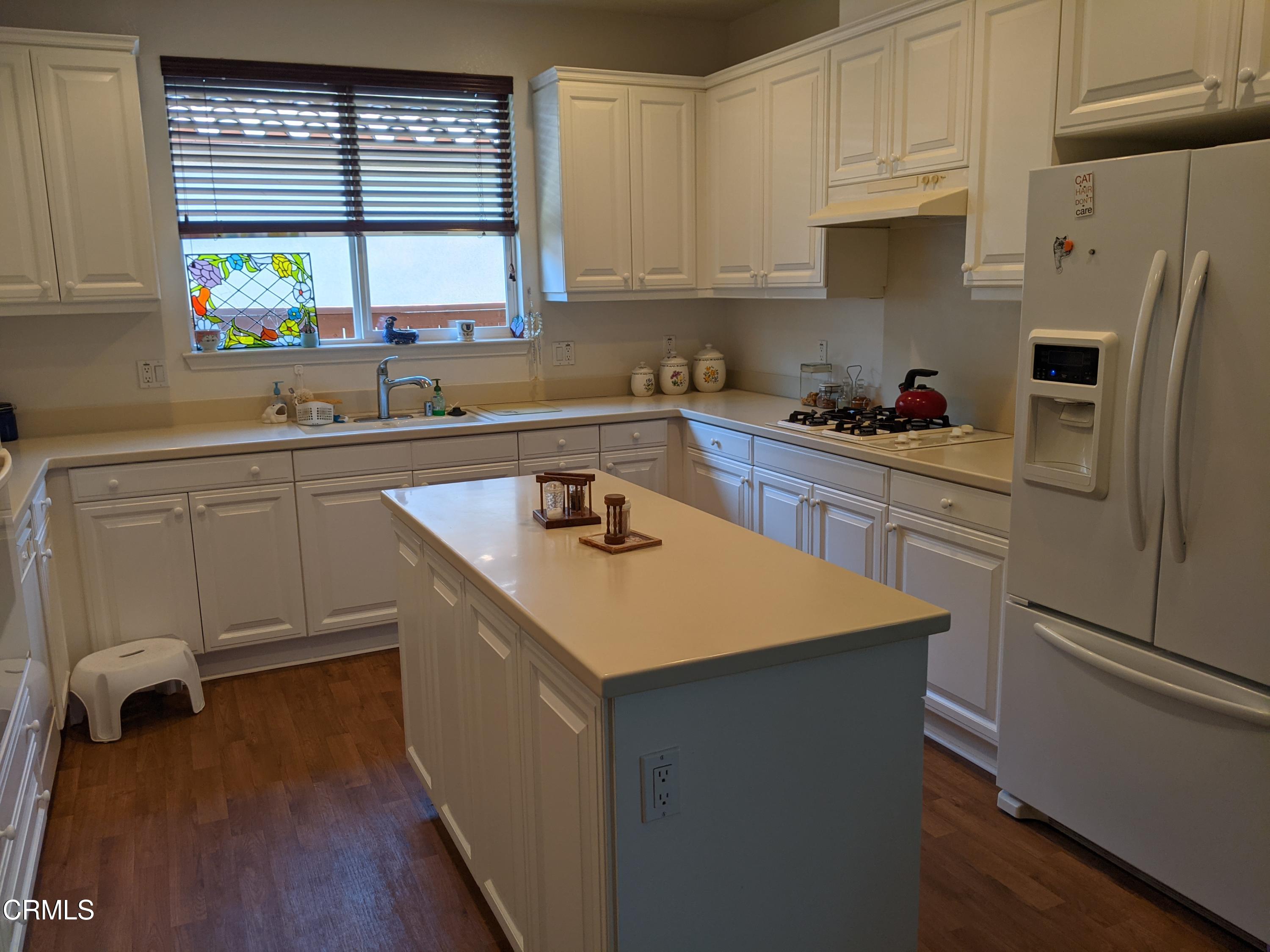 2654 Traditions Loop Paso Robles, CA 93446 - Photo 13 of 32 a kitchen with a sink stove and refrigerator