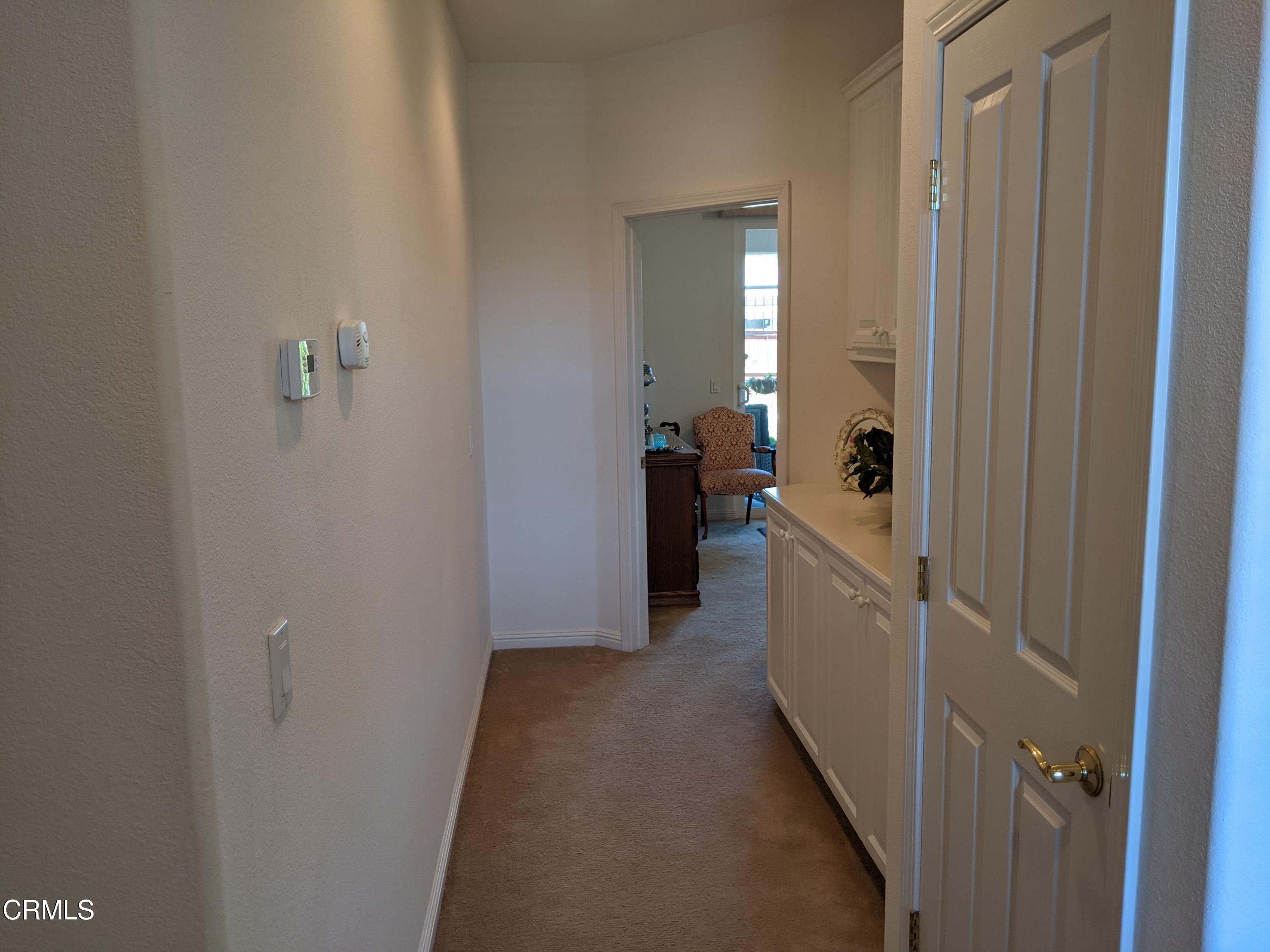 2654 Traditions Loop Paso Robles, CA 93446 - Photo 20 of 32 a view of a hallway with a white car parked in a small yard