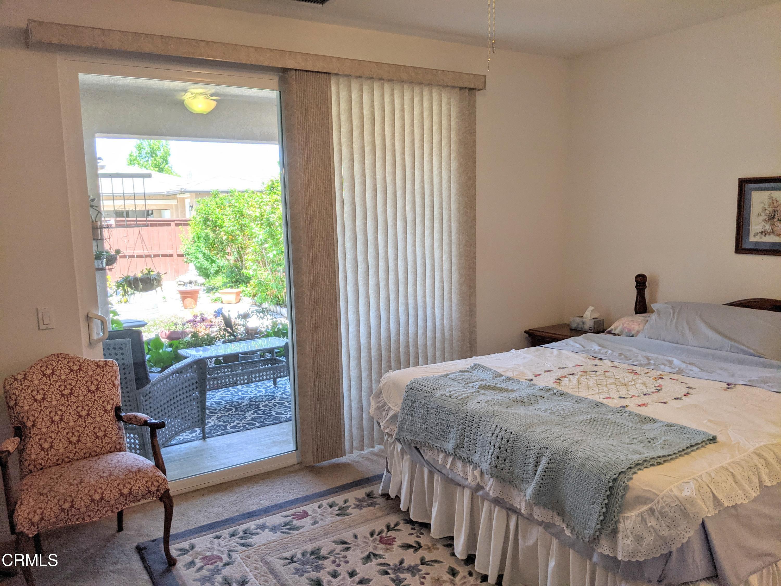 2654 Traditions Loop Paso Robles, CA 93446 - Photo 21 of 32 a bedroom with a bed and wooden floor