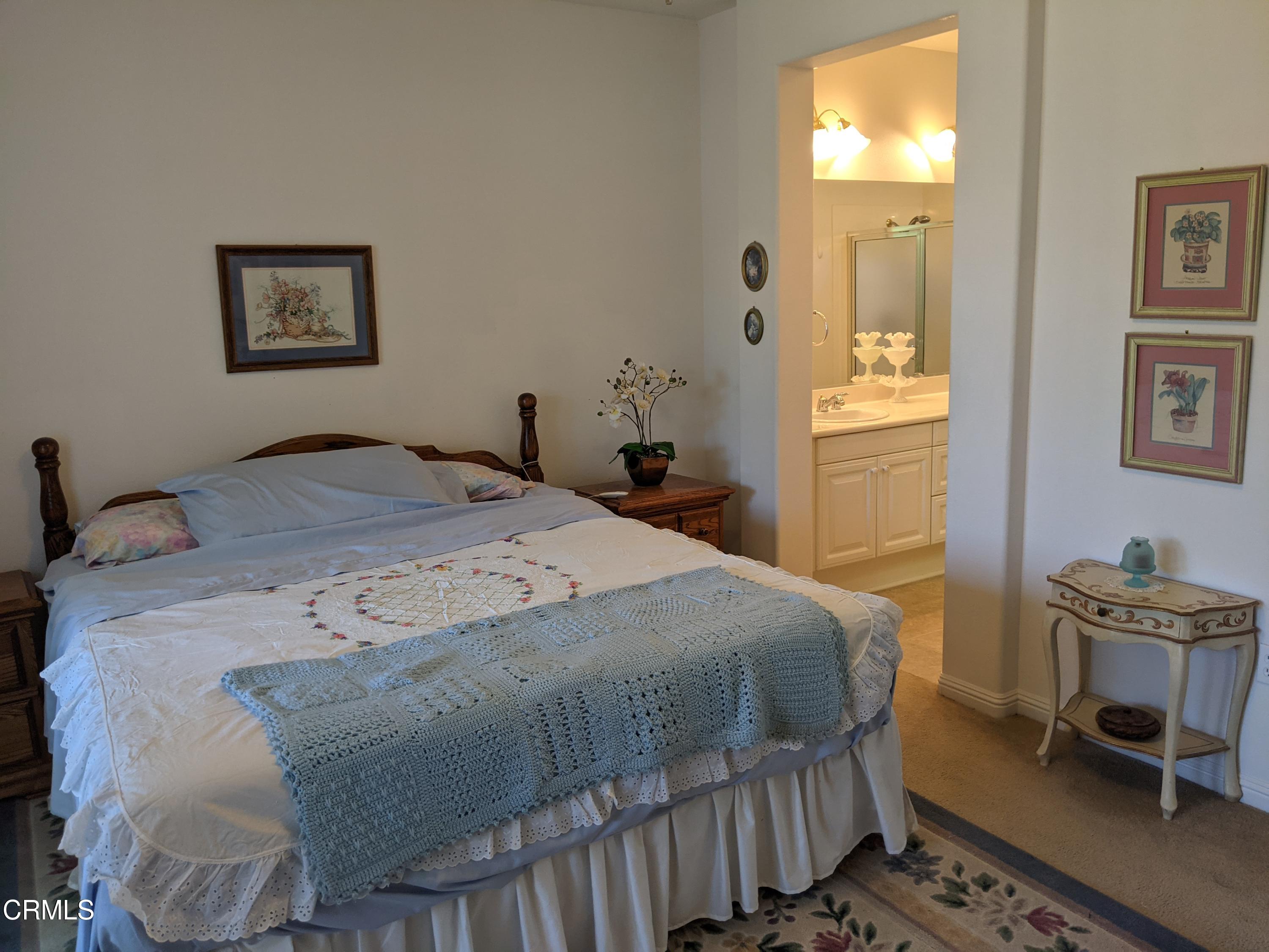 2654 Traditions Loop Paso Robles, CA 93446 - Photo 22 of 32 a bedroom with a bed and a table in it