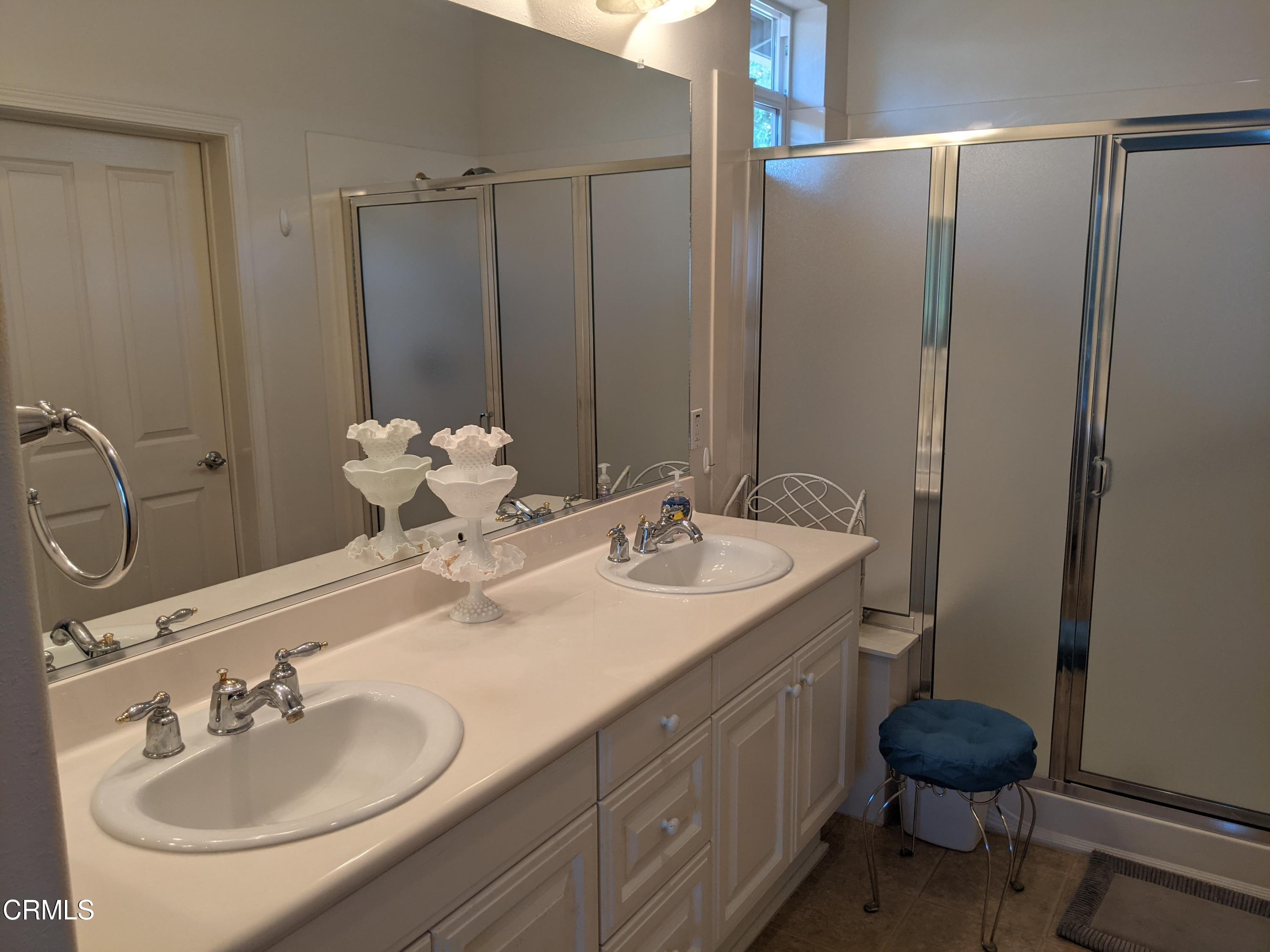 2654 Traditions Loop Paso Robles, CA 93446 - Photo 23 of 32 a bathroom with a sink and a mirror
