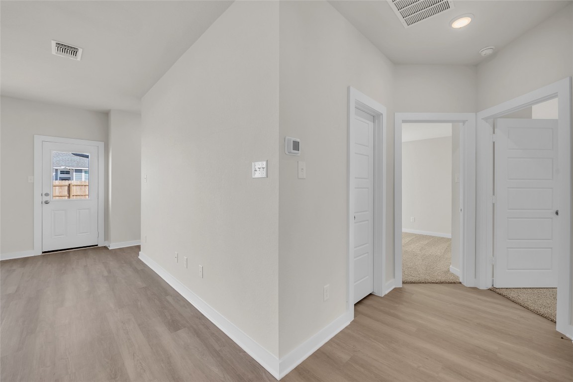 121 Walk Way Jarrell, TX 76537 - Photo 20 of 29 Corridor with recessed lighting, light wood-style floors, visible vents, and baseboards