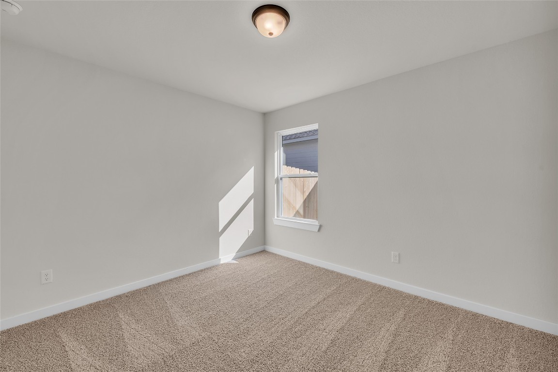 121 Walk Way Jarrell, TX 76537 - Photo 4 of 29 Unfurnished room featuring carpet flooring and baseboards