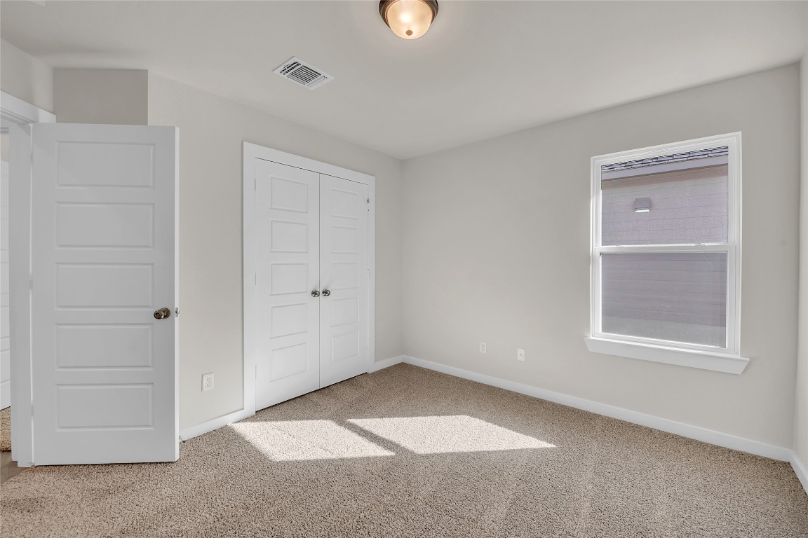 121 Walk Way Jarrell, TX 76537 - Photo 7 of 29 Unfurnished bedroom featuring a closet, visible vents, baseboards, and carpet