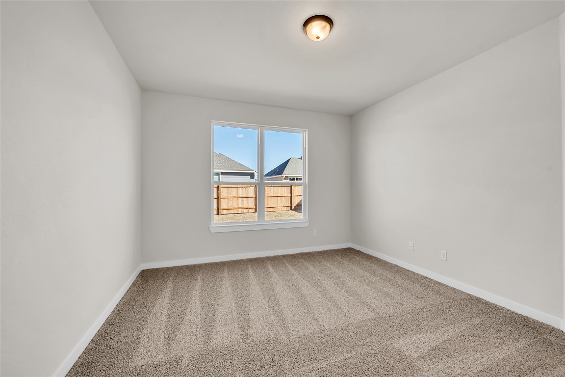 121 Walk Way Jarrell, TX 76537 - Photo 8 of 29 Empty room with carpet flooring and baseboards