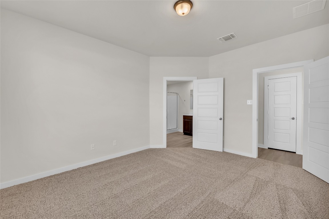 121 Walk Way Jarrell, TX 76537 - Photo 9 of 29 Unfurnished bedroom featuring visible vents, baseboards, and carpet
