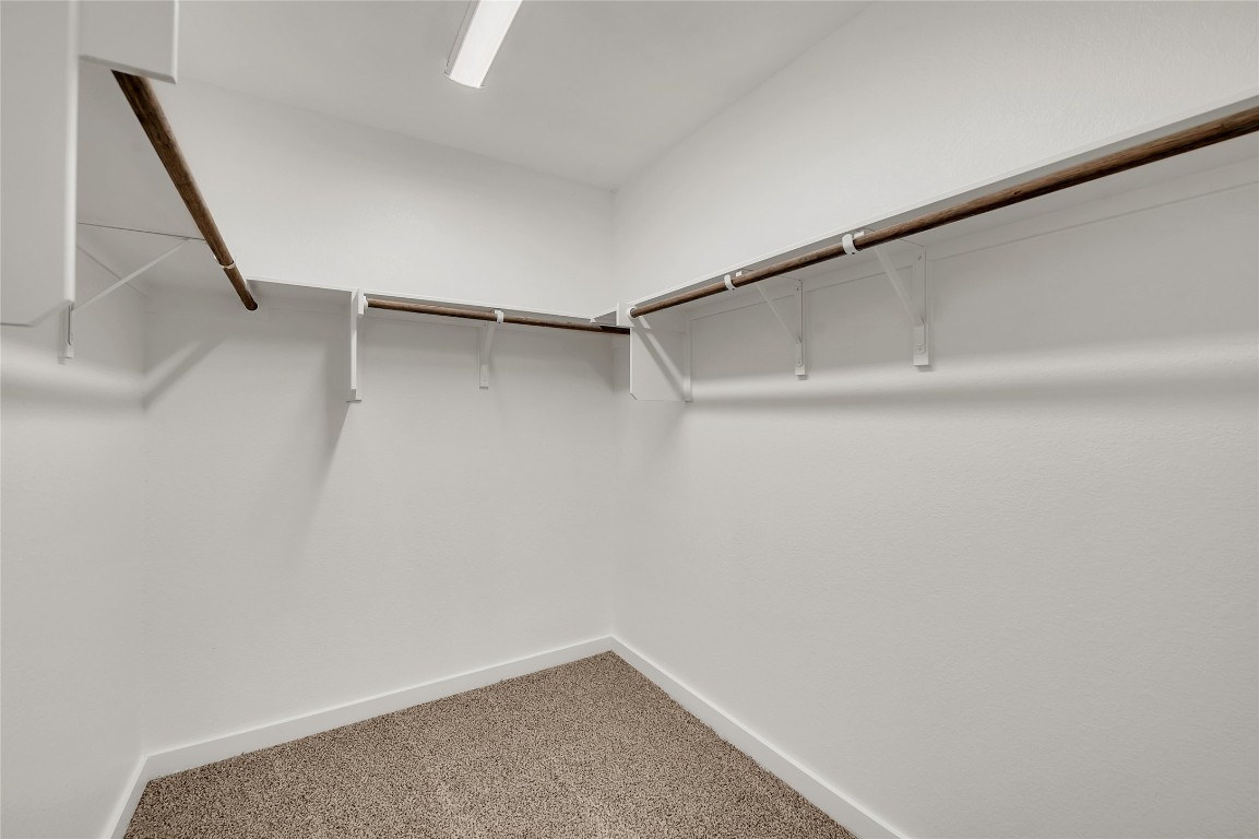 121 Walk Way Jarrell, TX 76537 - Photo 10 of 29 Walk in closet with carpet