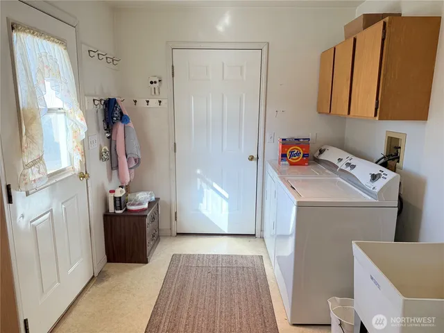 a view of storage and utility room with washer and dryer