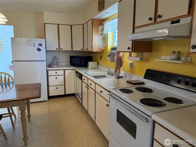 a kitchen with a stove a sink and a refrigerator