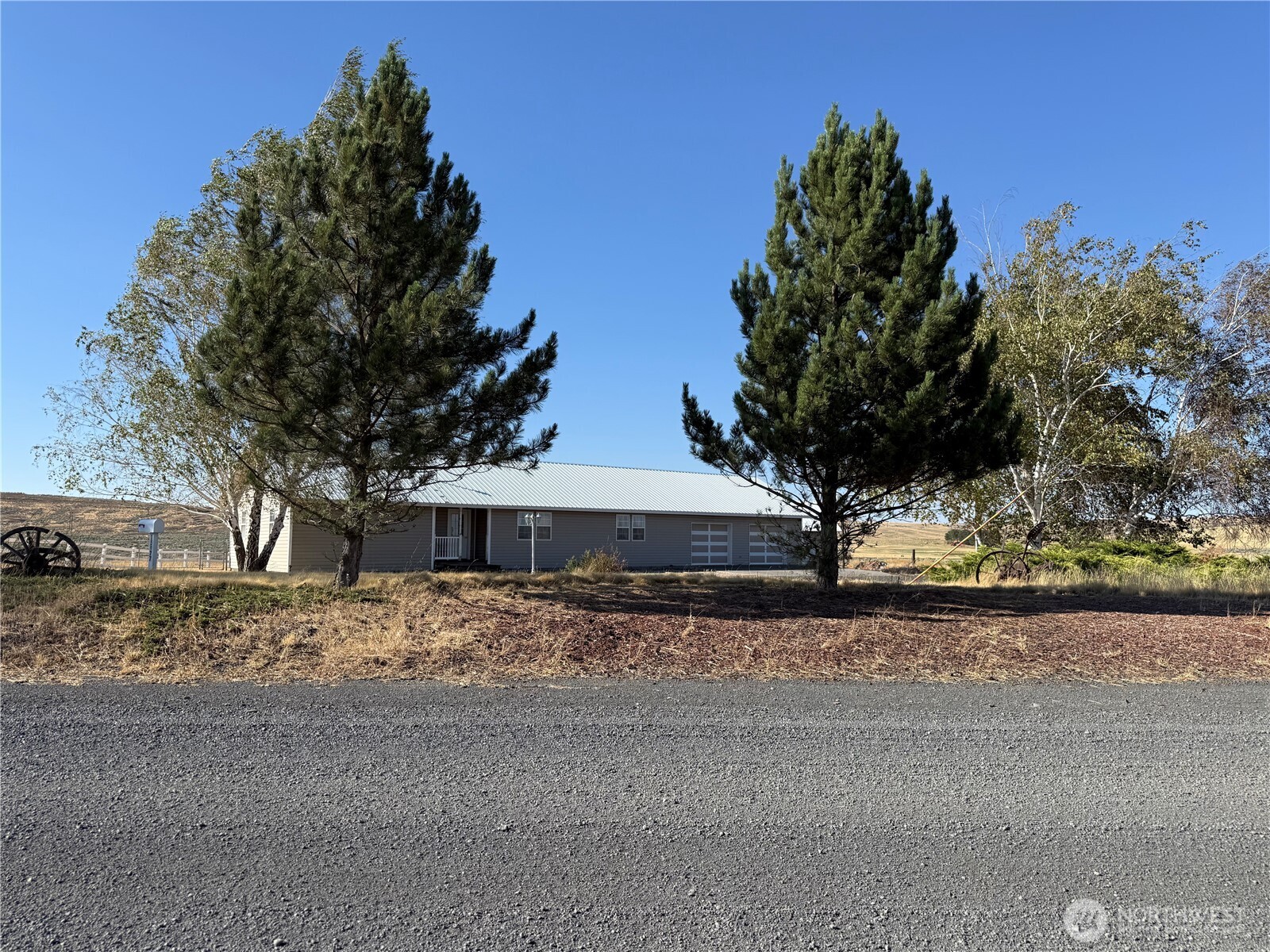 15977 Laney Bros Road East Odessa, WA 99159 - Photo 23 of 33 a white house that has a tree in front of it