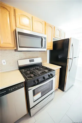a kitchen with stainless steel appliances granite countertop a stove and a microwave