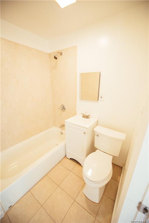 1443 Beach Avenue Bronx, NY 10460 - Photo 16 of 25 a white toilet sitting next to a bathroom sink and vanity