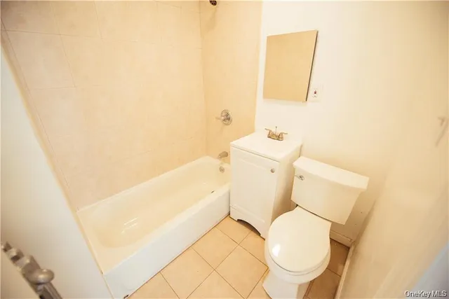 a white toilet sitting next to a bathroom sink