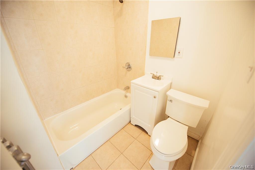 1443 Beach Avenue Bronx, NY 10460 - Photo 17 of 25 a white toilet sitting next to a bathroom sink