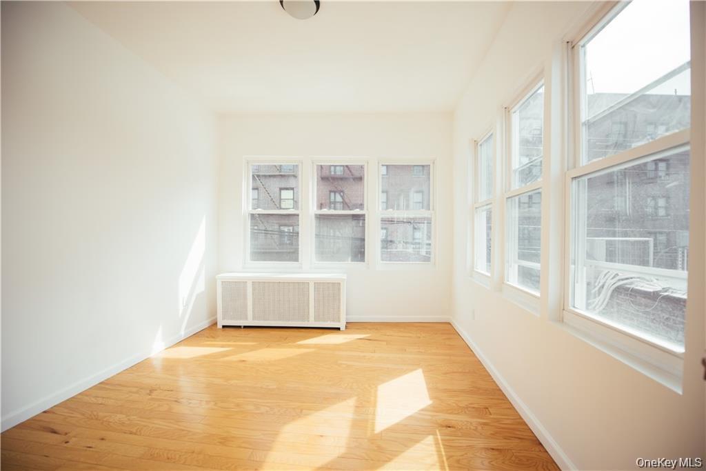 1443 Beach Avenue Bronx, NY 10460 - Photo 19 of 25 a view of an empty room with a window