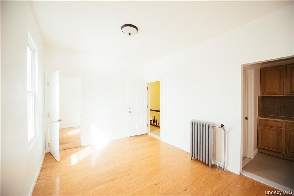 1443 Beach Avenue Bronx, NY 10460 - Photo 23 of 25 a view of a hallway to a room with wooden floor