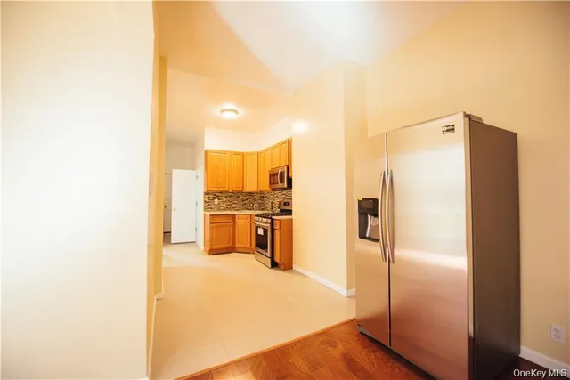 a view of a kitchen with a refrigerator and a sink
