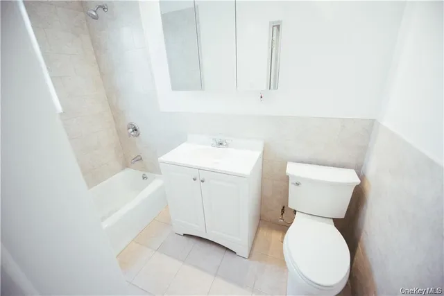 a white toilet sitting next to a bathroom sink