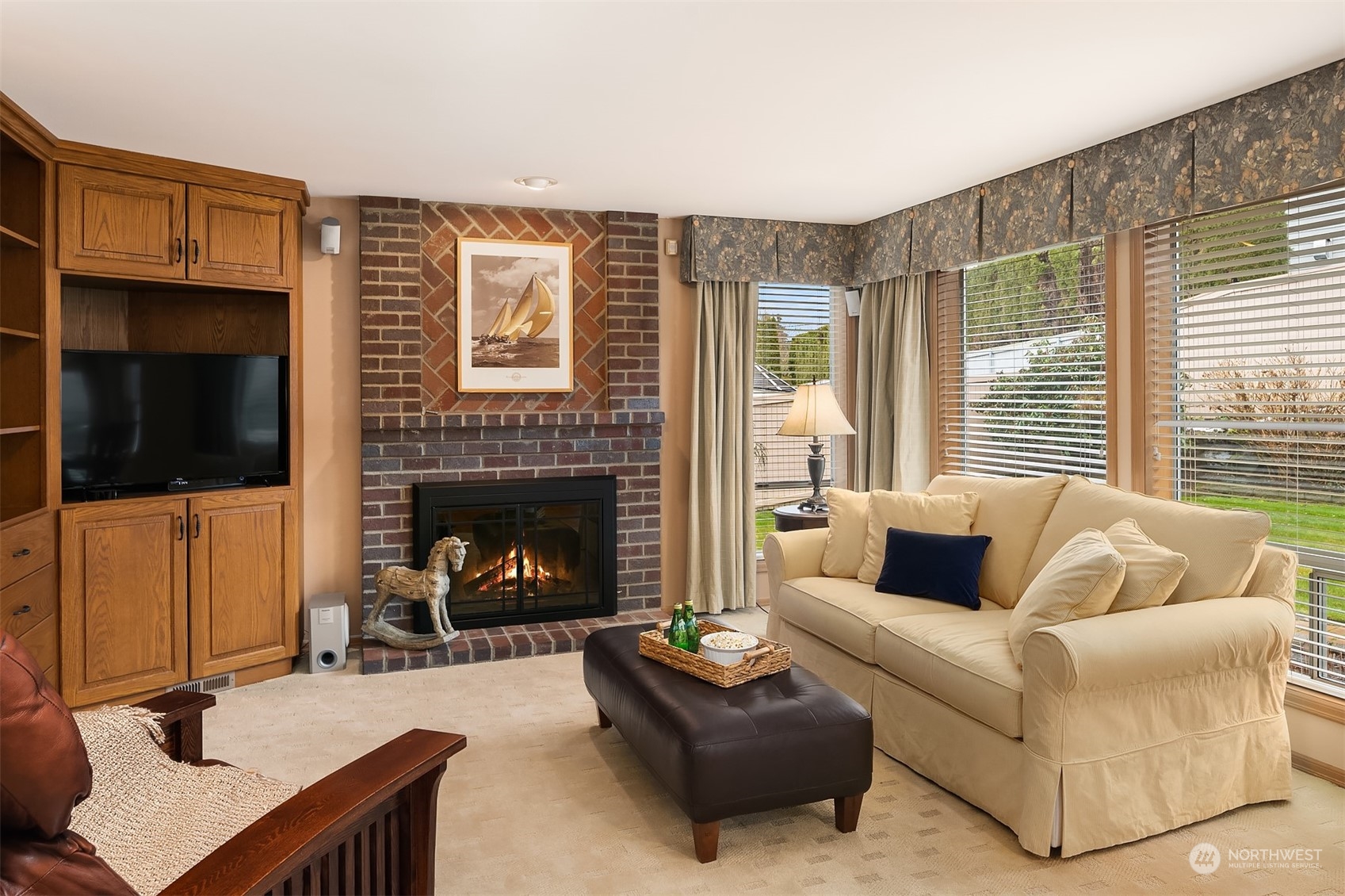 2224 237th Place Southeast Bothell, WA 98021 - Photo 13 of 40 a living room with furniture a flat screen tv and a fireplace