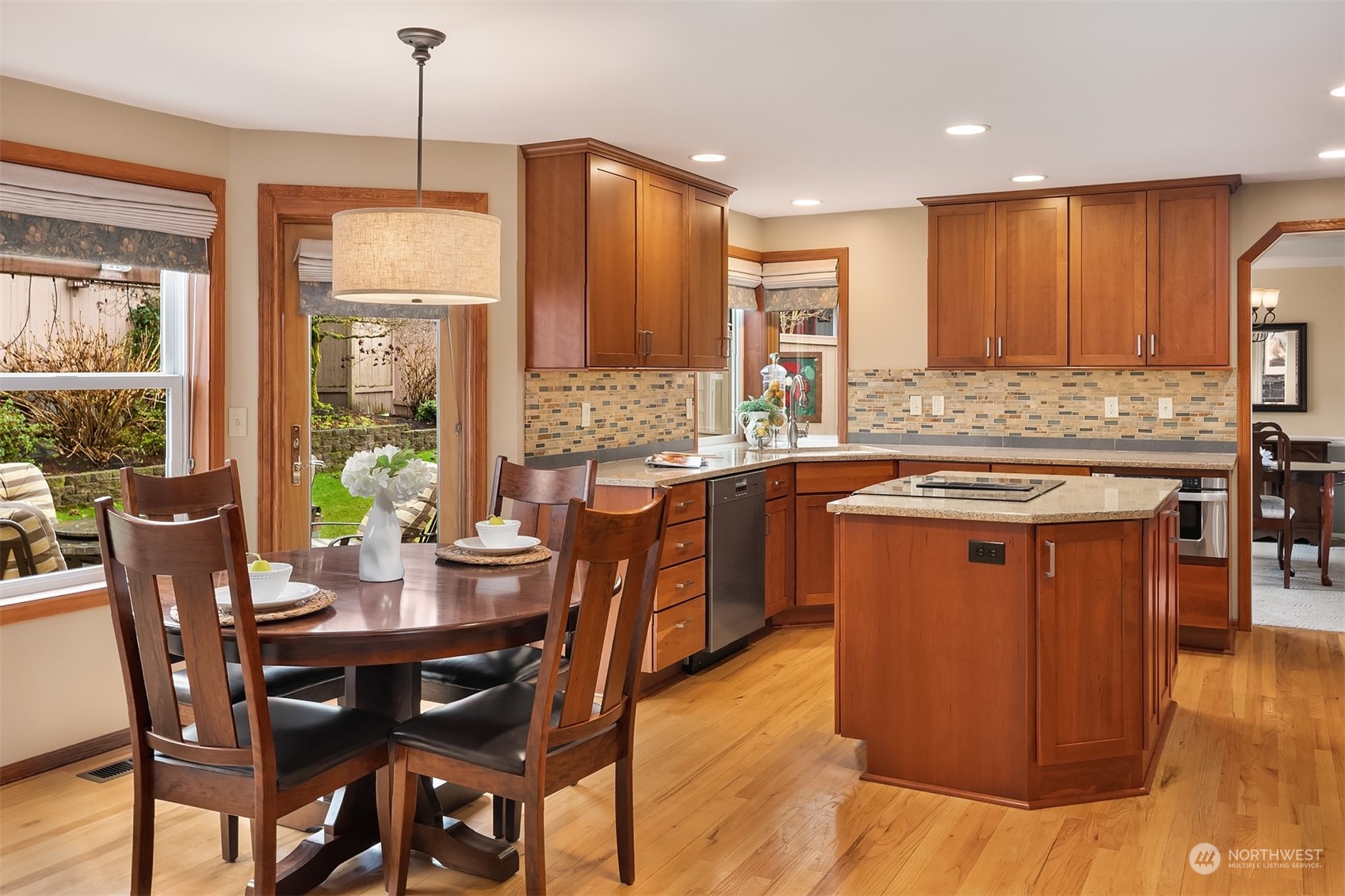 2224 237th Place Southeast Bothell, WA 98021 - Photo 17 of 40 a kitchen with stainless steel appliances granite countertop a table chairs and a refrigerator