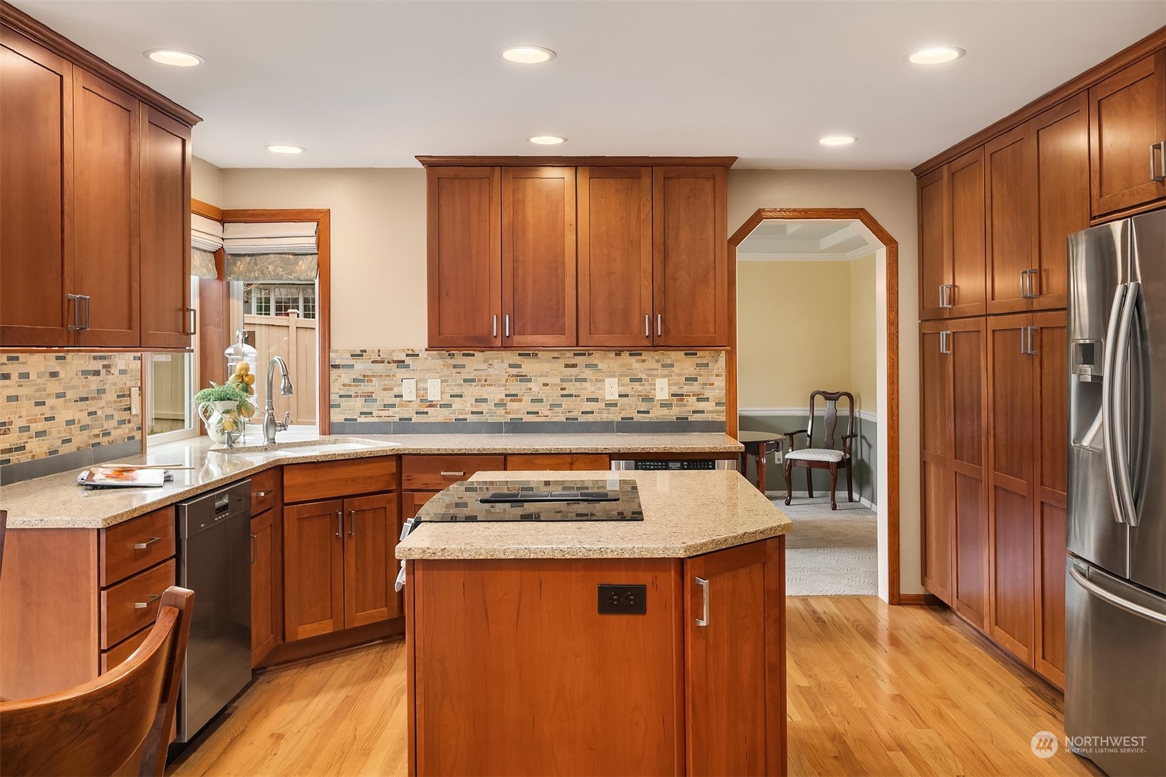 2224 237th Place Southeast Bothell, WA 98021 - Photo 18 of 40 a kitchen with stainless steel appliances granite countertop a refrigerator a sink dishwasher and wooden cabinets with wooden floor