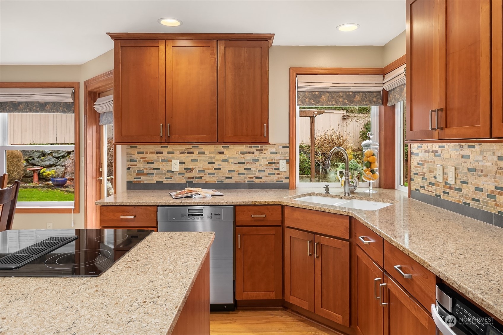 2224 237th Place Southeast Bothell, WA 98021 - Photo 23 of 40 a kitchen with stainless steel appliances granite countertop wooden cabinets a sink and a stove