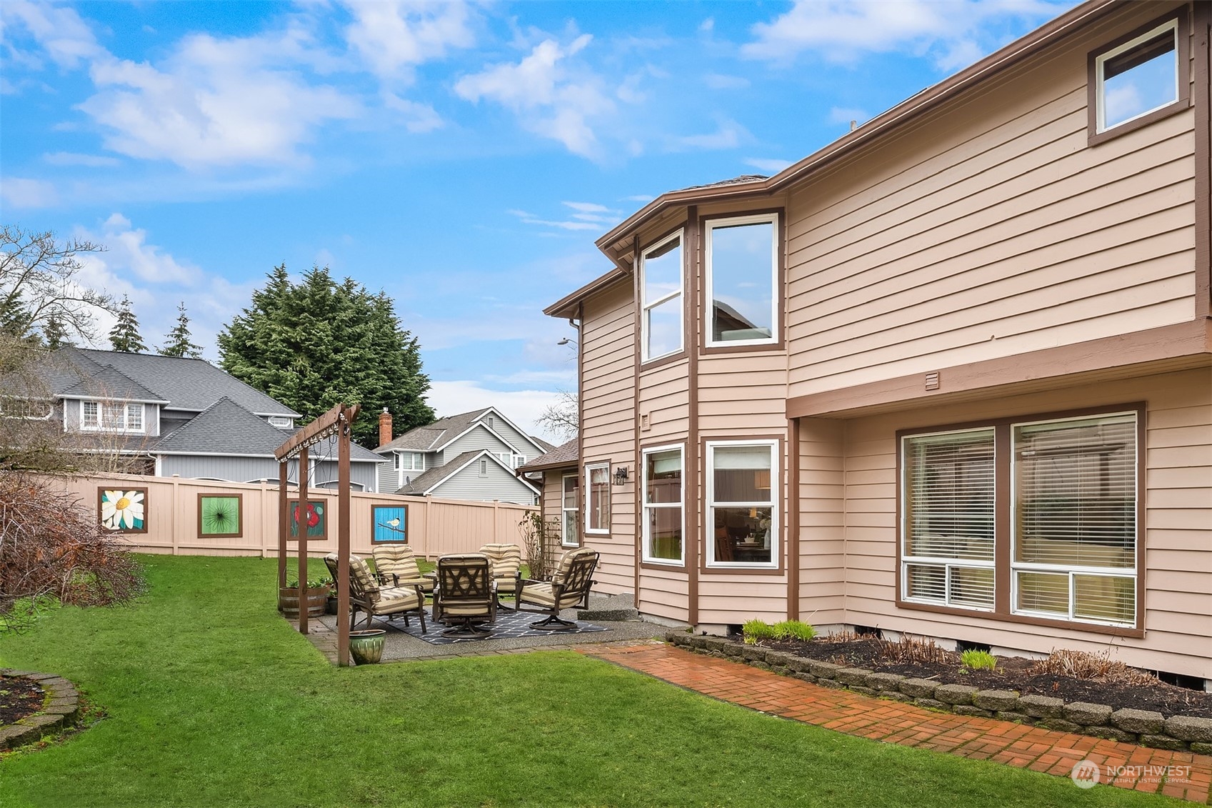 2224 237th Place Southeast Bothell, WA 98021 - Photo 38 of 40 a front view of a house with a garden and chairs
