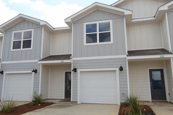 a front view of a house with garage