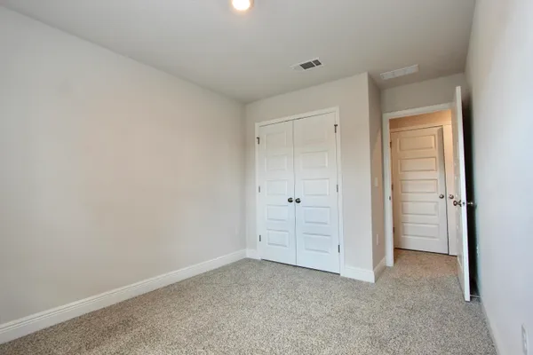 a view of an empty room and closet area
