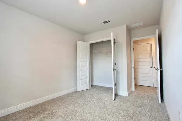 an empty room with closet area