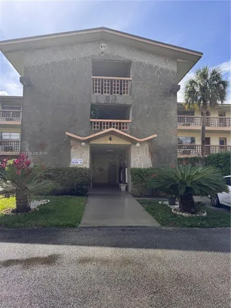 a front view of a house with plants