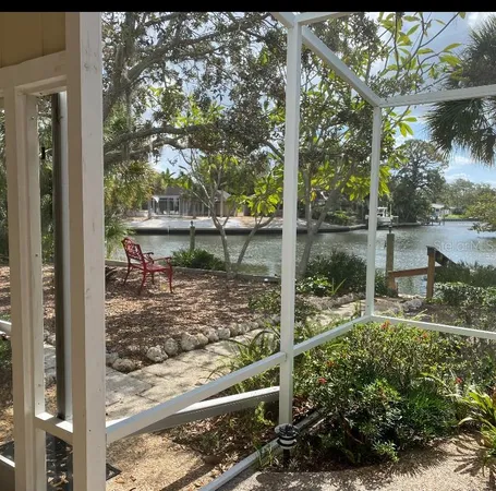 a view of a yard with table and chairs and potted plants
