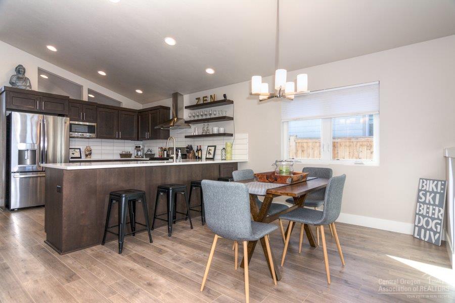 62013 Dantili Road Bend, OR 97701 - Photo 9 of 25 a view of a dining room with furniture window and wooden floor