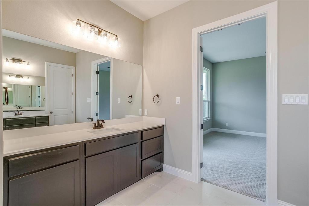 2316 Builder Road Crowley, TX 76036 - Photo 26 of 34 a en suite bathroom with a sink and mirror