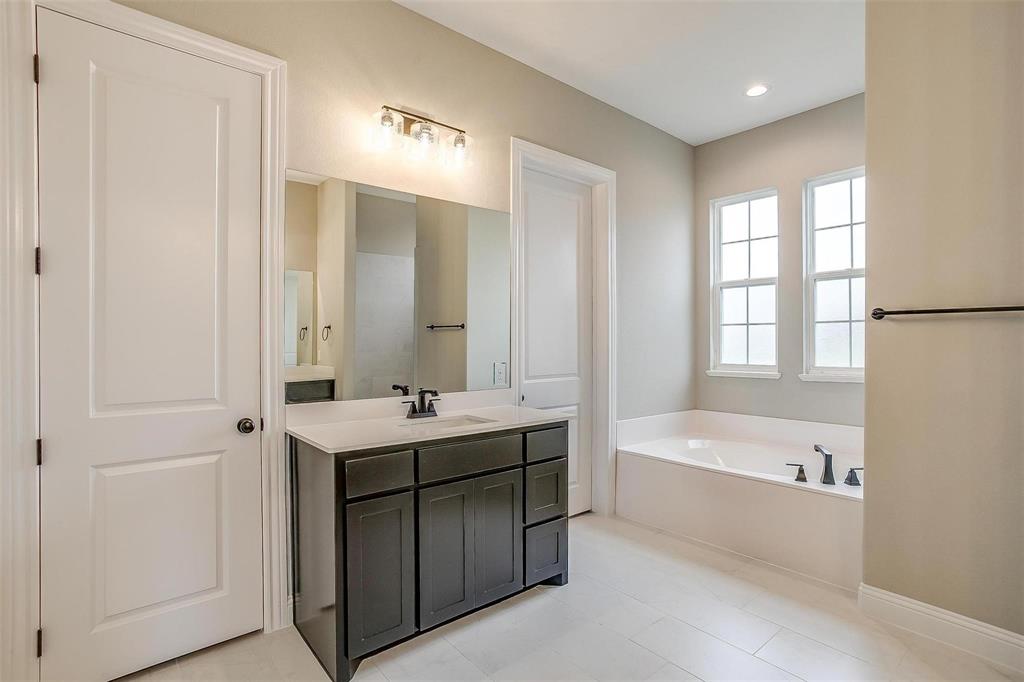 2316 Builder Road Crowley, TX 76036 - Photo 27 of 34 a bathroom with a tub sink and mirror