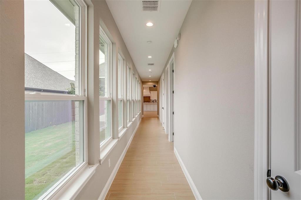 2316 Builder Road Crowley, TX 76036 - Photo 28 of 34 a view of a hallway with wooden floor and staircase