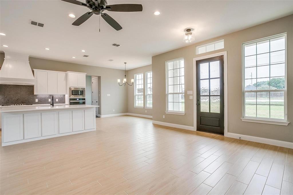 2316 Builder Road Crowley, TX 76036 - Photo 7 of 34 a view of an empty room with a kitchen and a window