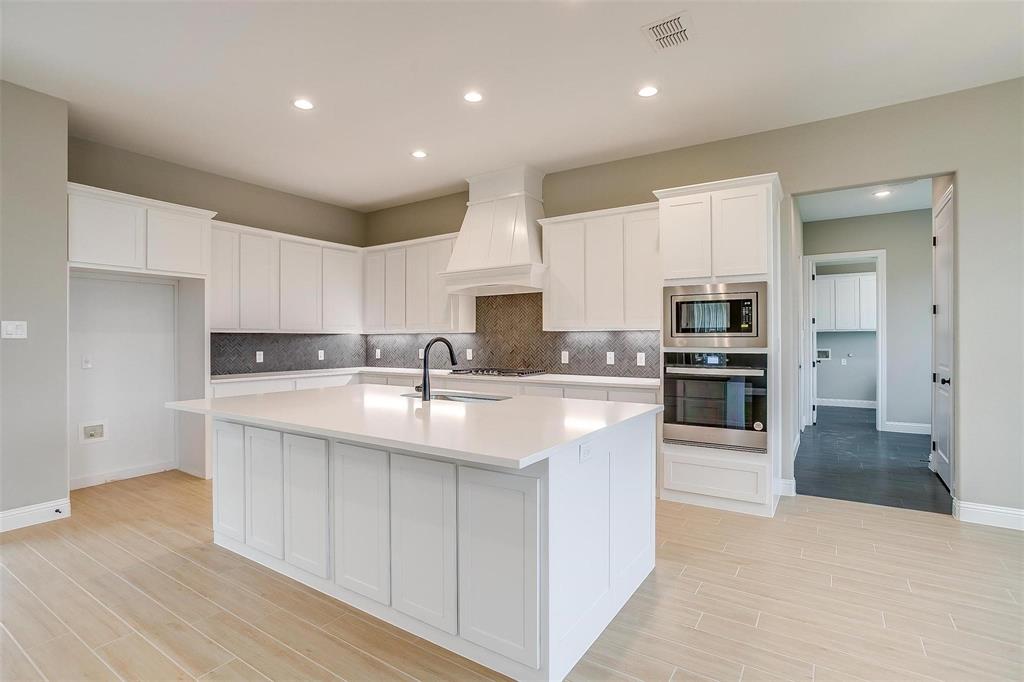 2316 Builder Road Crowley, TX 76036 - Photo 9 of 34 a large kitchen with stainless steel appliances and white cabinets