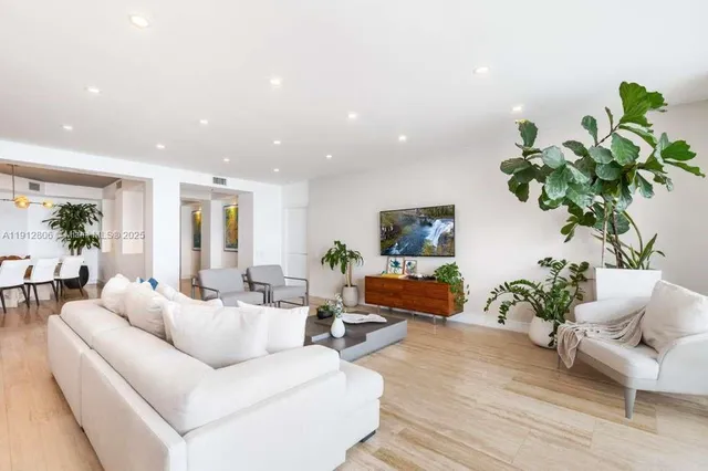 a living room with furniture and baby crib