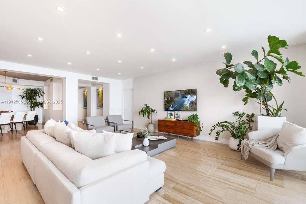 808 Brickell Key Drive, Unit 2504 Miami, FL 33131 - Photo 11 of 26 a living room with furniture potted plant and a window