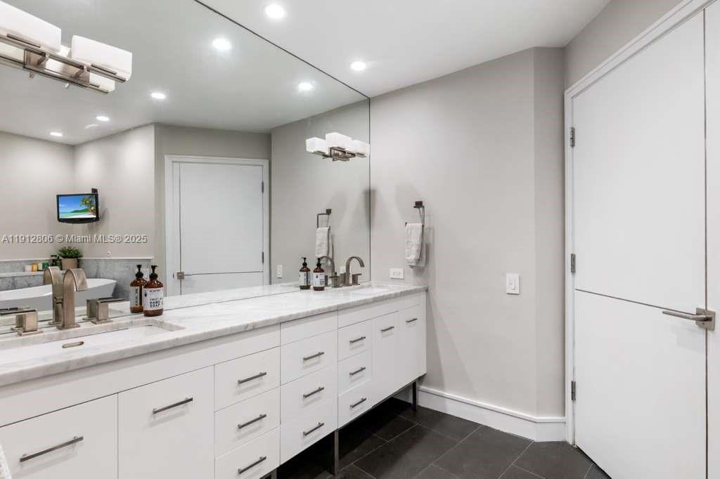 808 Brickell Key Drive, Unit 2504 Miami, FL 33131 - Photo 15 of 26 a bathroom with a double vanity sink and a mirror
