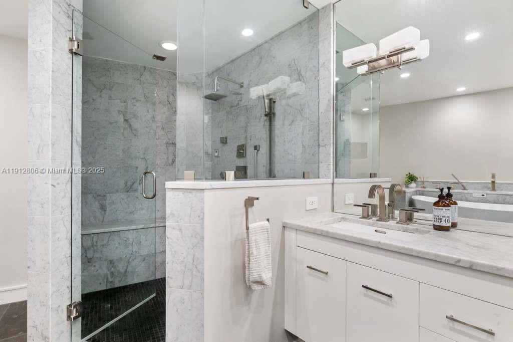808 Brickell Key Drive, Unit 2504 Miami, FL 33131 - Photo 16 of 26 a bathroom with a double vanity sink mirror and shower