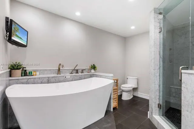 a bathroom with a shower and a bath tub