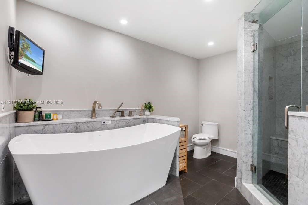 808 Brickell Key Drive, Unit 2504 Miami, FL 33131 - Photo 17 of 26 a bathroom with a sink a toilet and a mirror