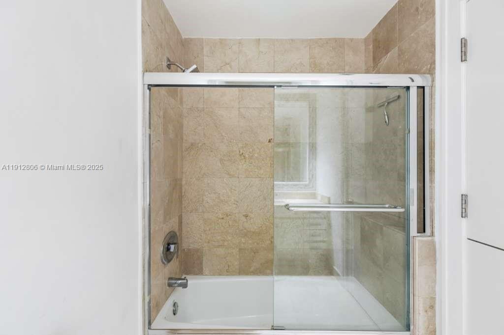 808 Brickell Key Drive, Unit 2504 Miami, FL 33131 - Photo 18 of 26 a bathroom with a shower and a bath tub