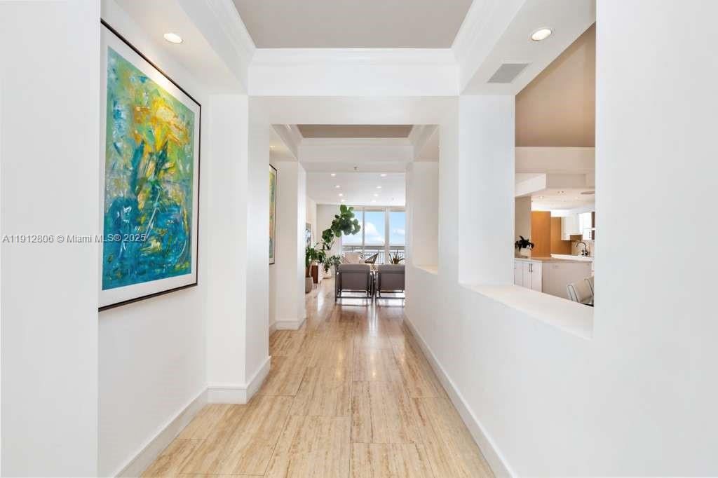 808 Brickell Key Drive, Unit 2504 Miami, FL 33131 - Photo 20 of 26 a view of a hallway with wooden floor and a living room
