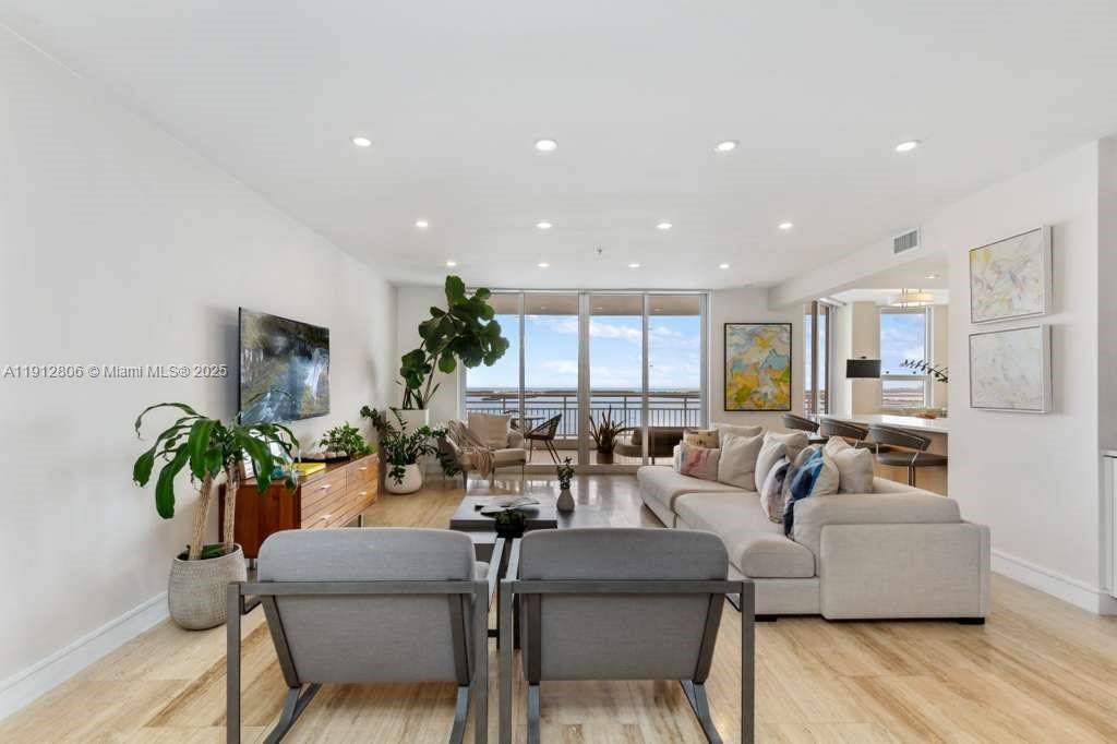 808 Brickell Key Drive, Unit 2504 Miami, FL 33131 - Photo 21 of 26 a living room with furniture kitchen view and a potted plant