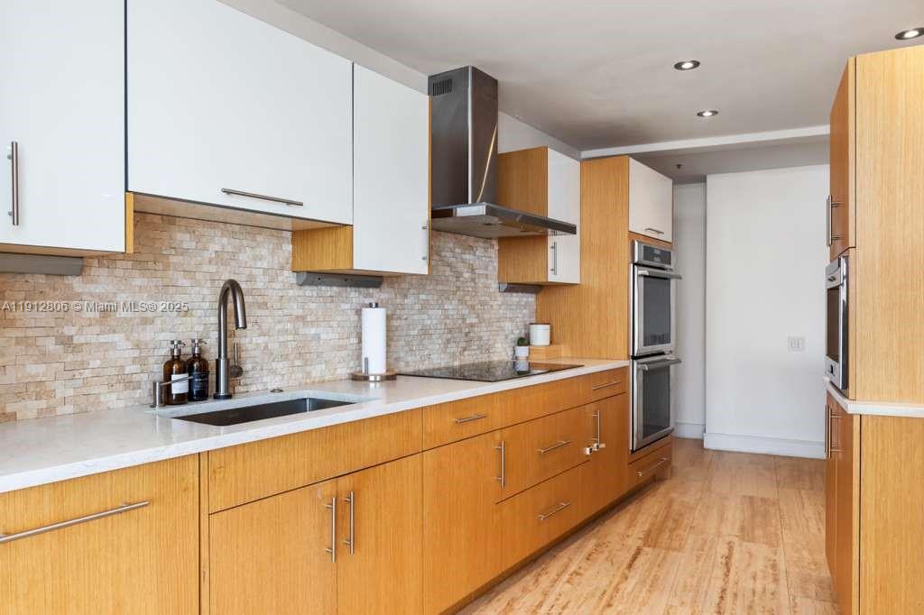 808 Brickell Key Drive, Unit 2504 Miami, FL 33131 - Photo 4 of 26 a kitchen with stainless steel appliances a sink stove and refrigerator