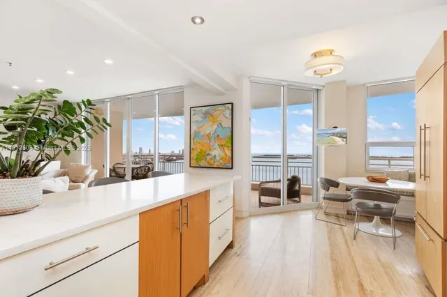 a kitchen that has a microwave a stove and white cabinets